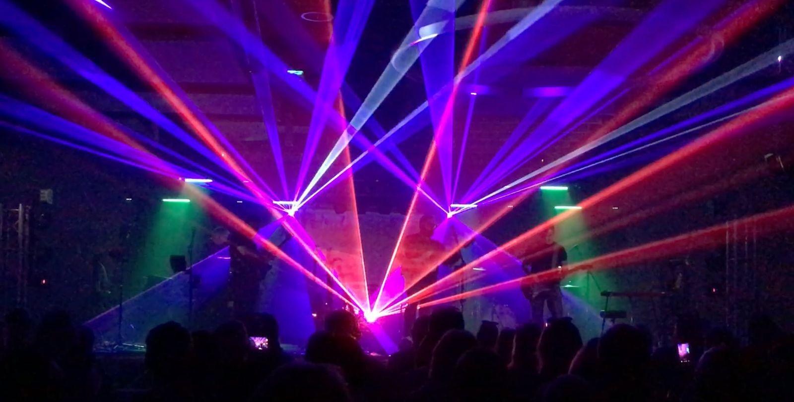 Stage lighting and laser beams above the room