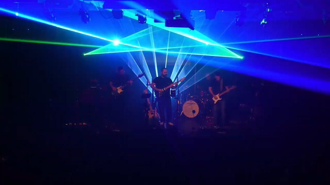 Blue and green laser beams in the room