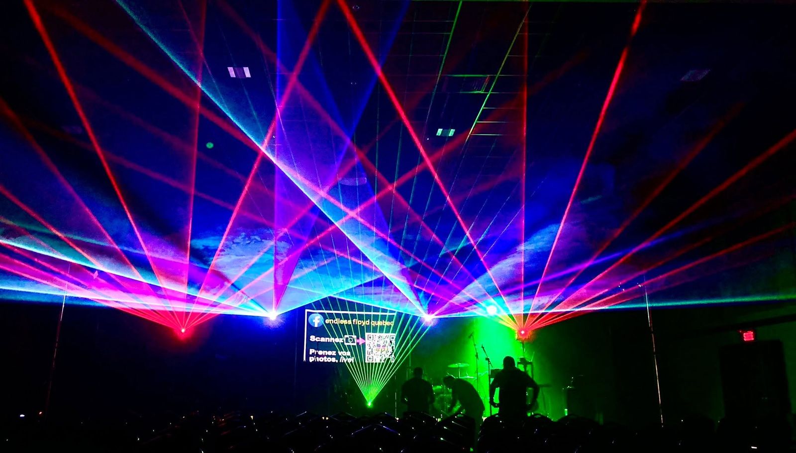 The endless floyd sign on stage, surrounded by lasers
